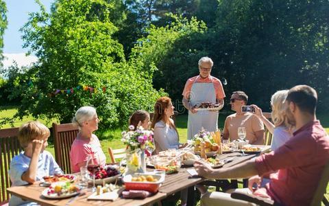 幸福的家庭所有正餐或夏花园社交聚会照片